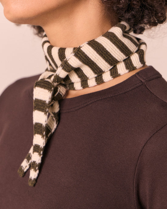 model wears olive and bone knitted skinny neckerchief