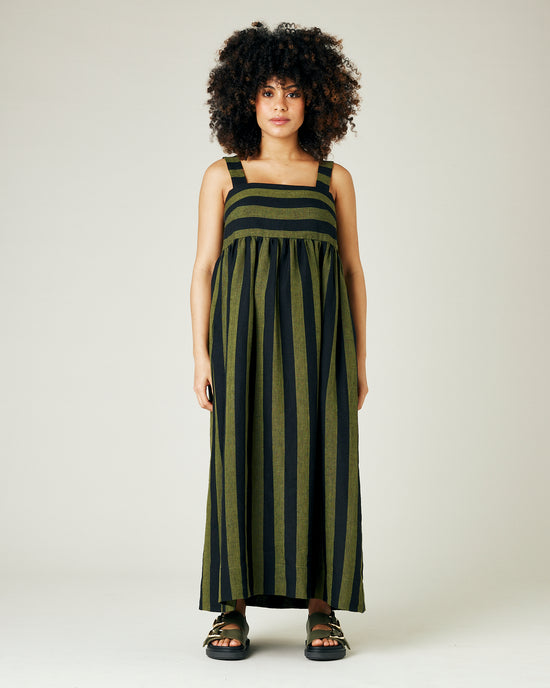 pregnant model wears olive and black stripe linen suki dress