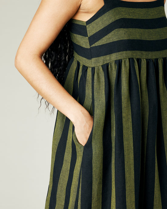 model wears olive and black stripe linen suki dress