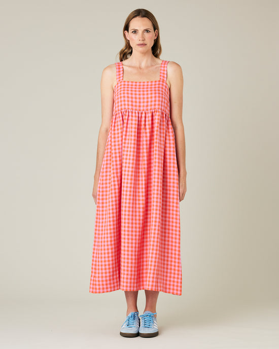 model wears tomato and pick check linen suki dress