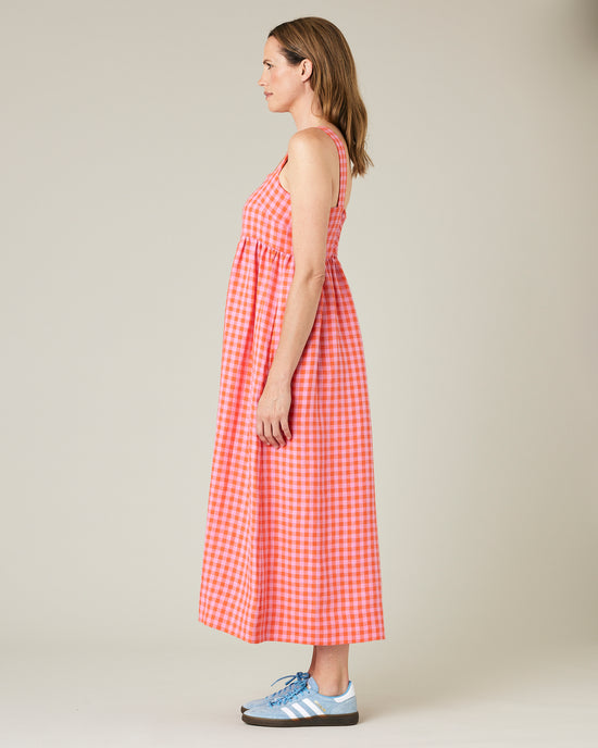 model wears tomato and pick check linen suki dress