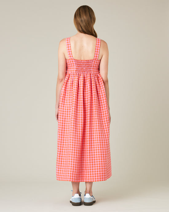 model wears tomato and pick check linen suki dress