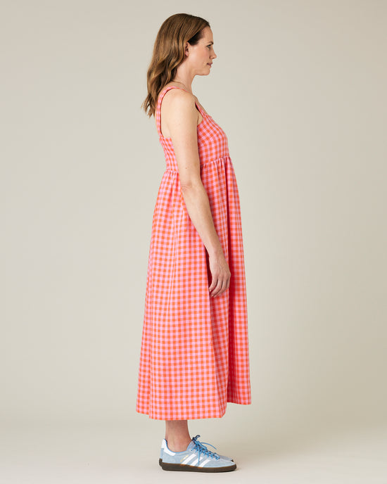 model wears tomato and pick check linen suki dress