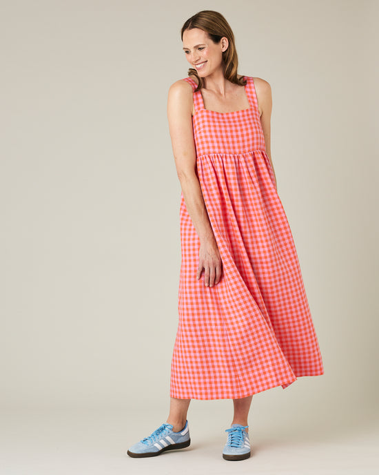 model wears tomato and pick check linen suki dress