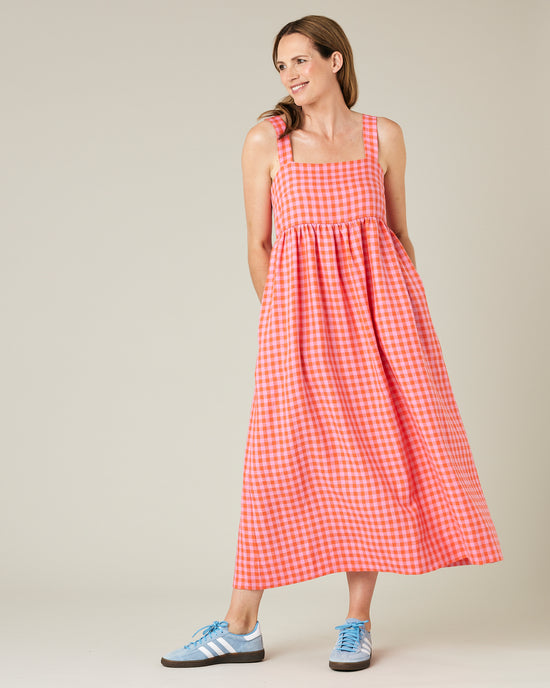 model wears tomato and pick check linen suki dress