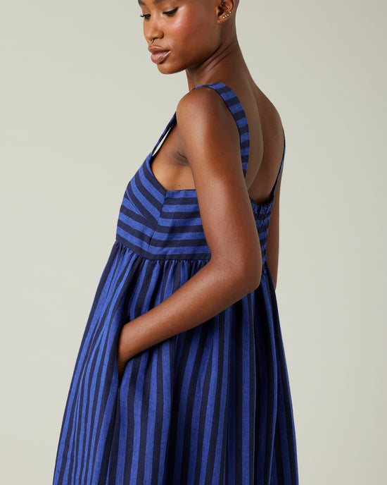 model wears indigo stripe linen suki dress