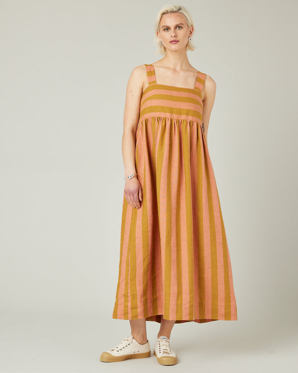 model wears pollen stripe suki linen dress