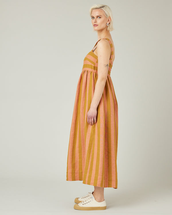model wears pollen stripe suki linen dress