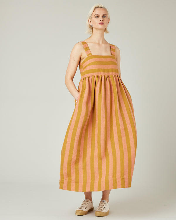 model wears pollen stripe suki linen dress
