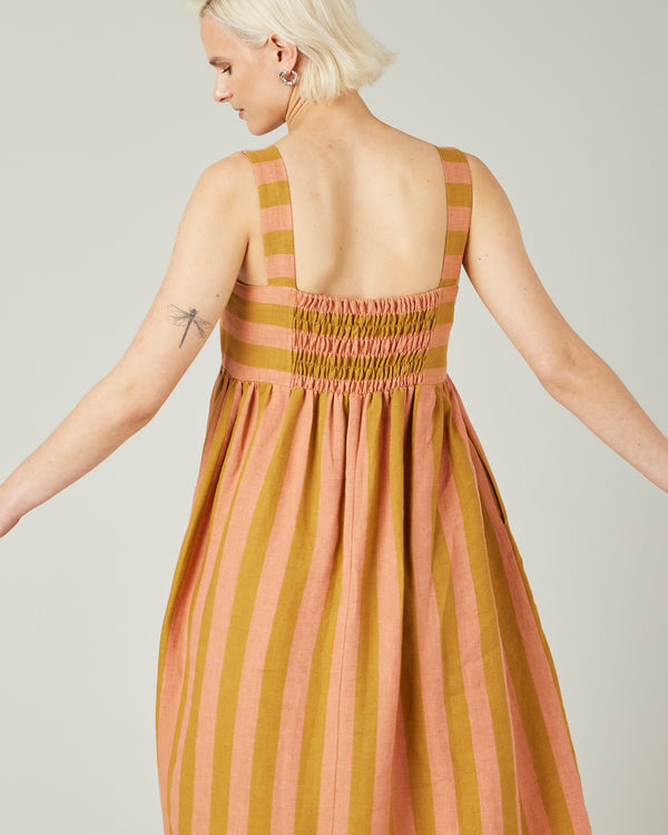 model wears pollen stripe suki linen dress