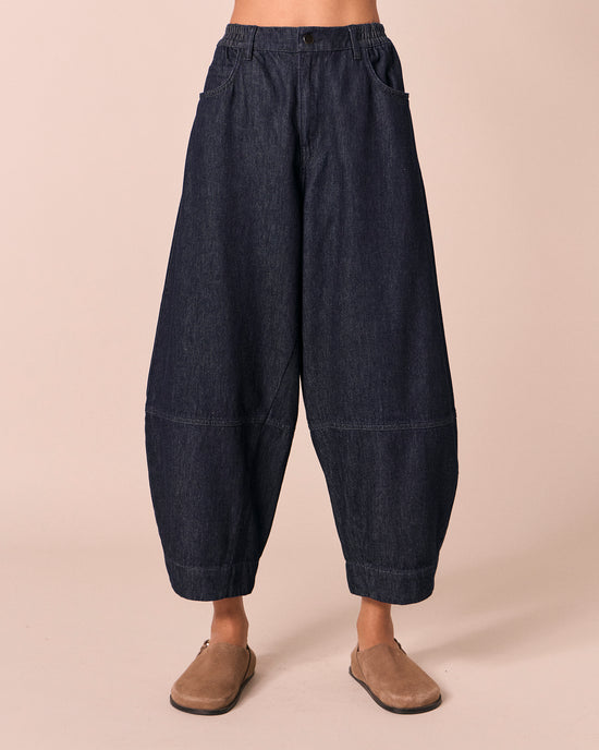 model wears sura indigo rinse wash denim jeans front