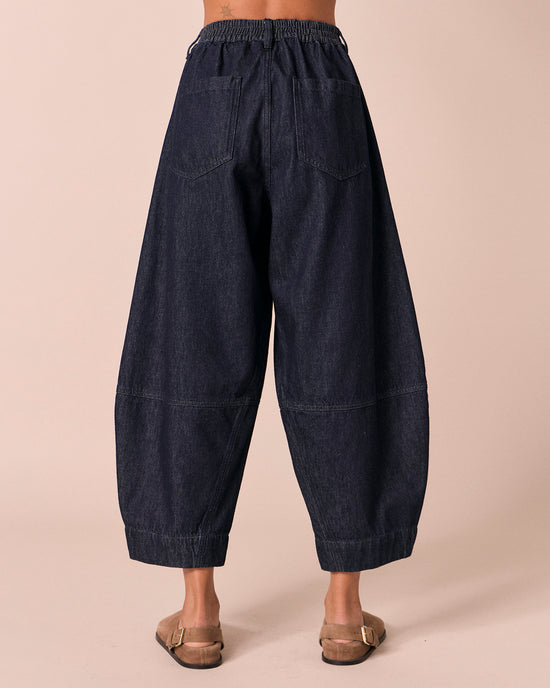 model wears sura indigo rinse wash denim jeans back