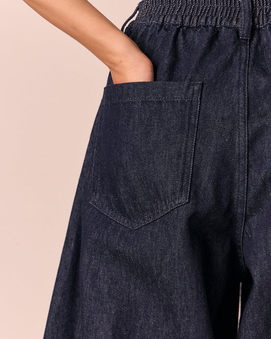 model wears sura indigo rinse wash denim jeans