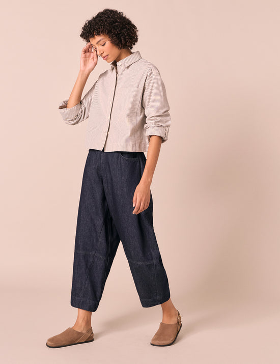 model wears sura indigo rinse wash denim jeans right