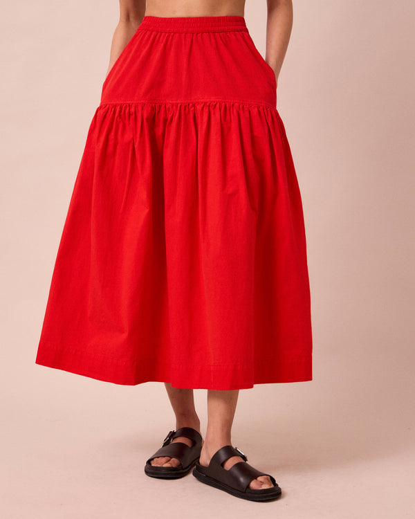 model wears talia chilli red cotton poplin skirt