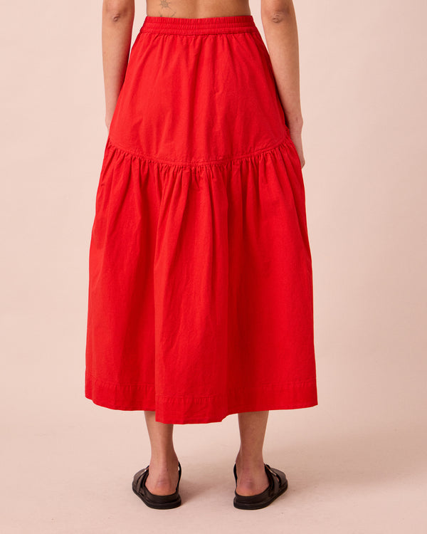 model wears talia chilli red cotton poplin skirt