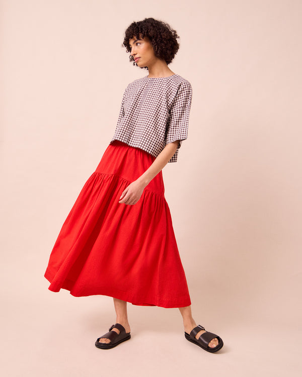 model wears talia chilli red cotton poplin skirt