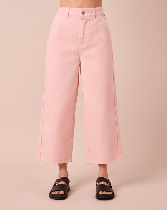 model wears tavi petal pink denim jeans front