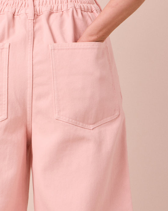 model wears tavi petal pink denim jeans 
