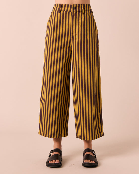 model wear tavi saffron and chocolate stripe jeans