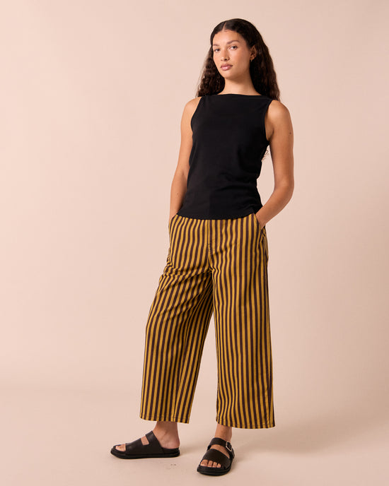 model wear tavi saffron and chocolate stripe jeans