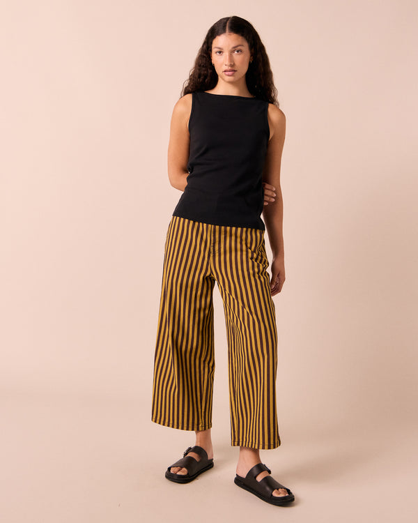 model wear tavi saffron and chocolate stripe jeans