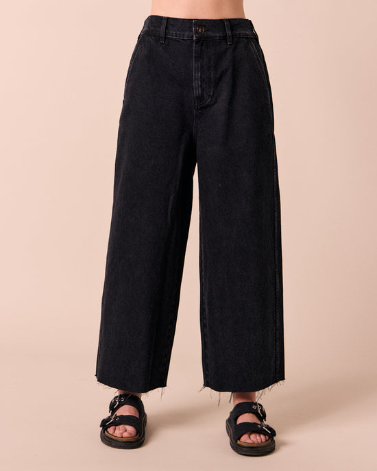 model wears tavi washed black denim jeans front