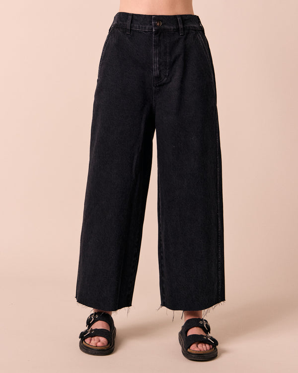 model wears tavi washed black denim jeans front