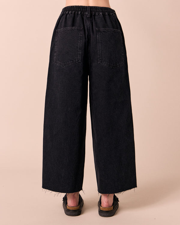 model wears tavi washed black denim jeans back