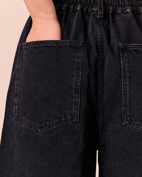 model wears tavi washed black denim jeans