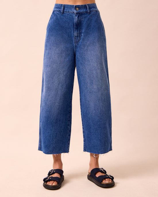 model wears tavi mid blue denim jeans front