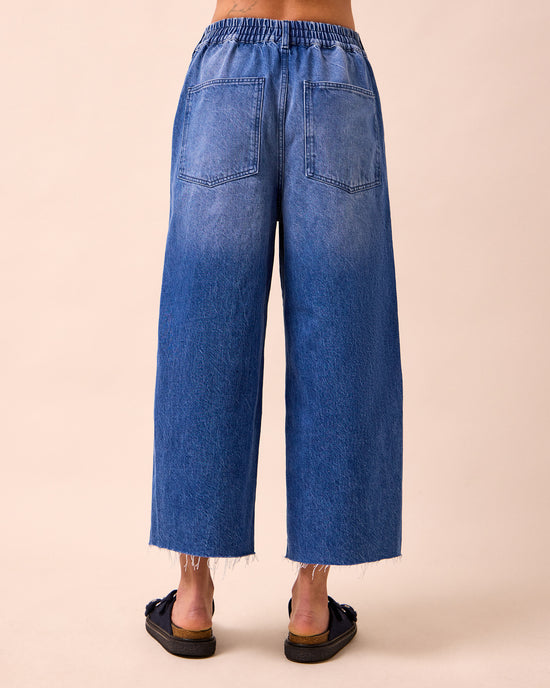 model wears tavi mid blue denim jeans back