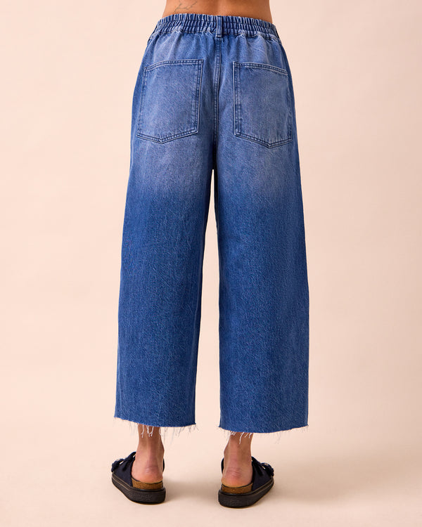 model wears tavi mid blue denim jeans back