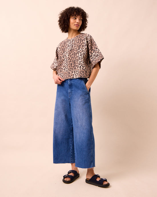 model wears tavi mid blue denim jeans left