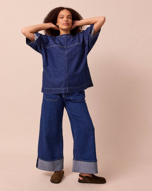 model wears teddi mid blue wash denim trousers right