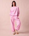 model wears tegan orchid pink fleeceback  jersey trousers left