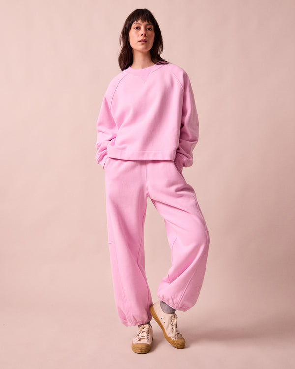 model wears tegan orchid pink fleeceback  jersey trousers left