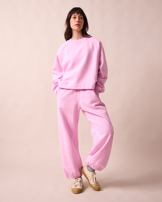 model wears tegan orchid pink fleeceback  jersey trousers left