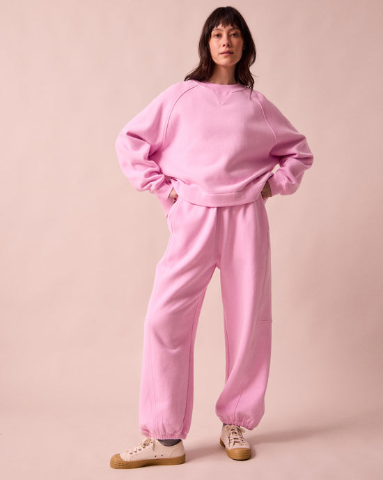 model wears tegan orchid pink fleeceback jersey trousers right