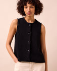 model wears tia black knitted vest