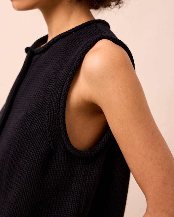 model wears tia black knitted vest