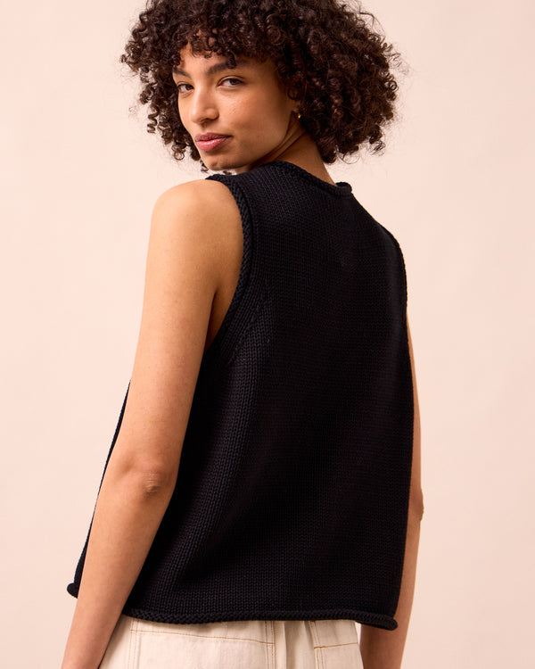 model wears tia black knitted vest