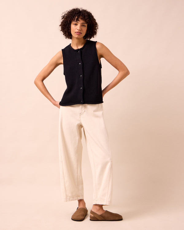 model wears tori ecru denim jeans left