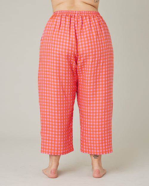 model wears tomato and pink check PJ trousers