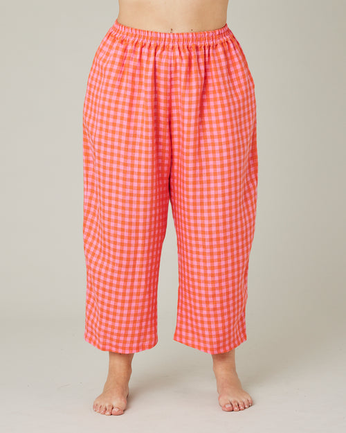 model wears tomato and pink check PJ trousers