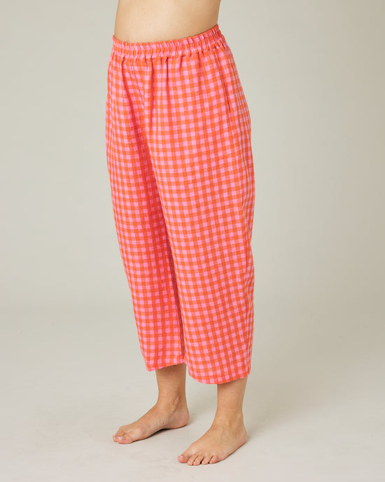 pregnant model wears tomato and pink check PJ trousers