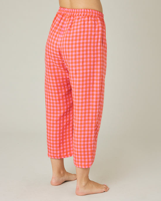 pregnant model wears tomato and pink check PJ trousers