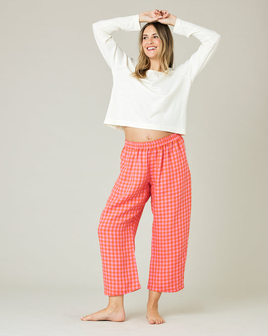 pregnant model wears tomato and pink check PJ trousers