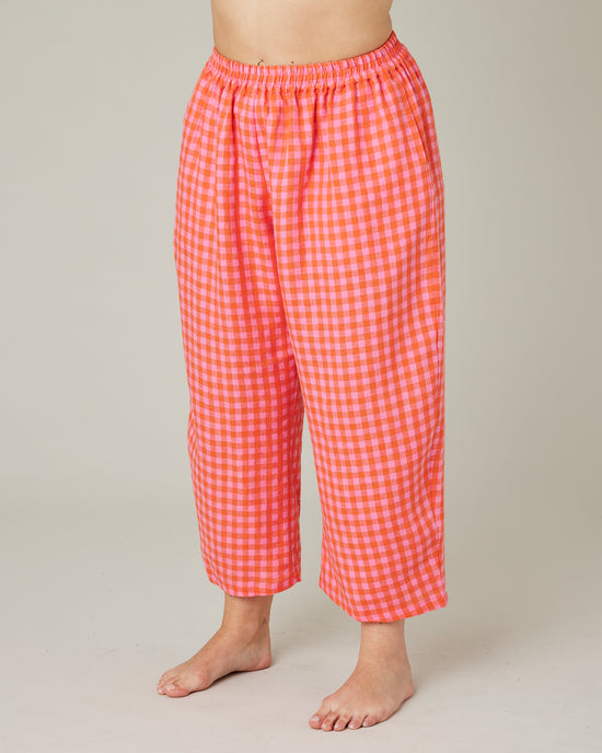 model wears tomato and pink check PJ trousers