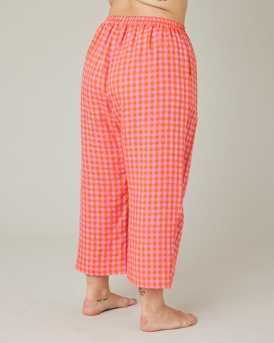 model wears tomato and pink check PJ trousers